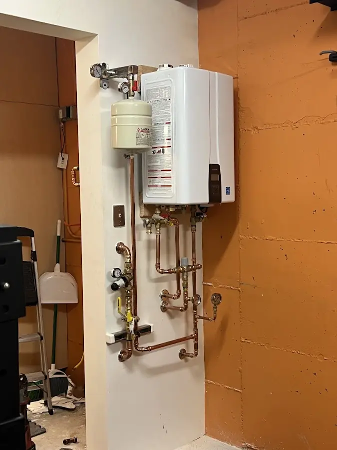 Plumbing technician inspecting water heater connections in Seabrook